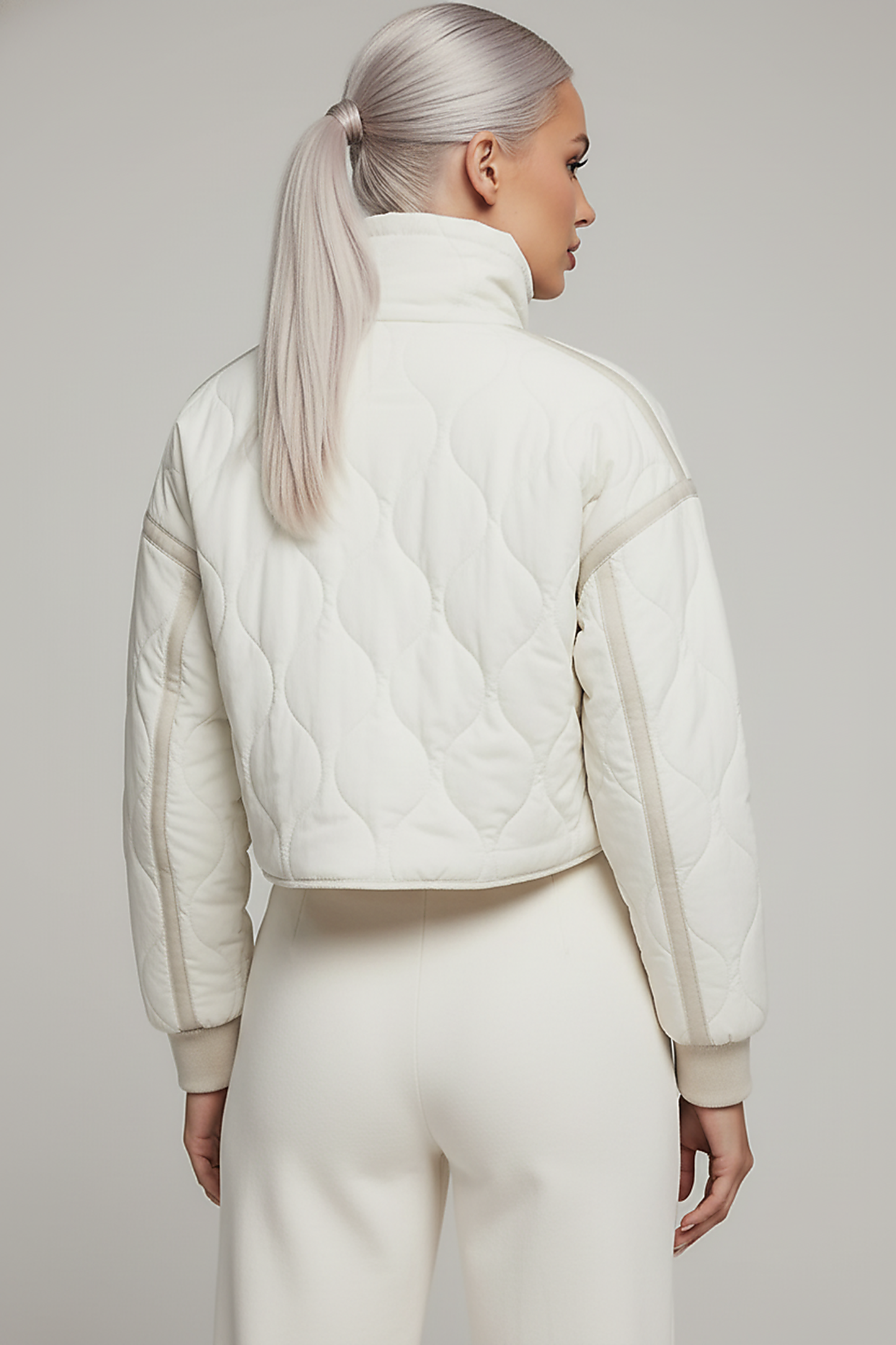 Stand-collar winter jacket, close-up of zipper and drawstring.