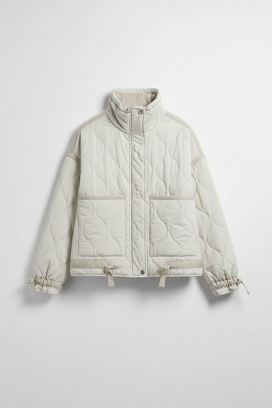 Stand-collar winter jacket, front view, model in motion.