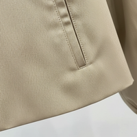 Womens beige trench coat, button closure detail.