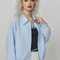 Beige short jacket, front view on model.