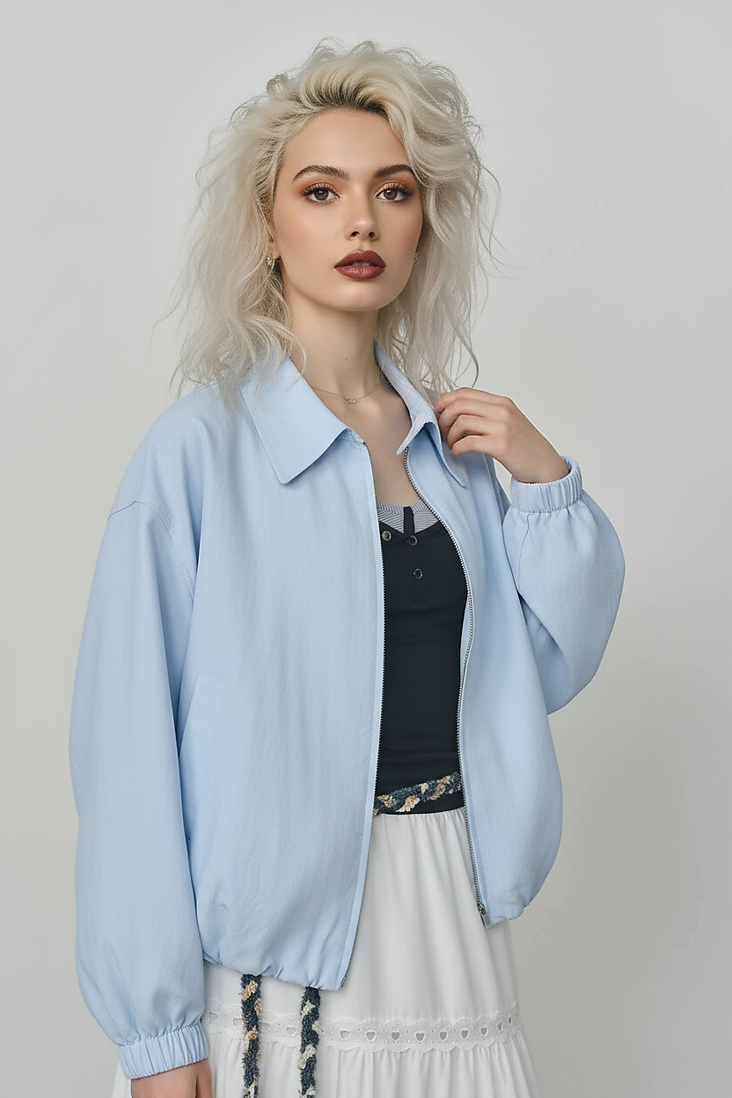 Beige short jacket, front view on model.