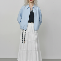 Beige short jacket, back view on model.