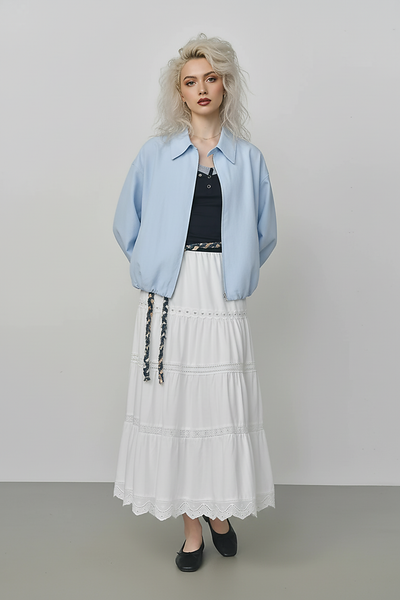 Beige short jacket, back view on model.