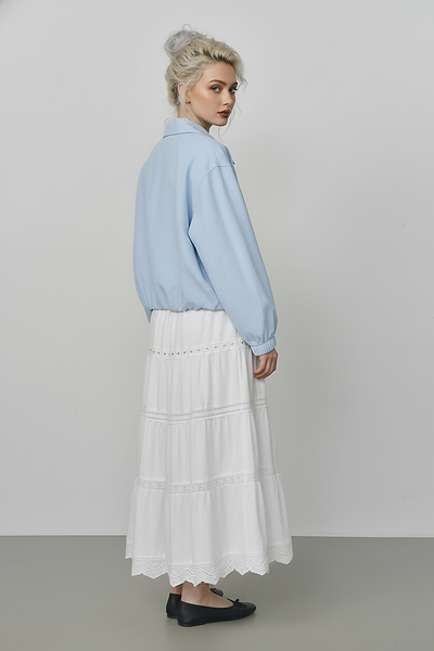 Beige short jacket, side view on model.