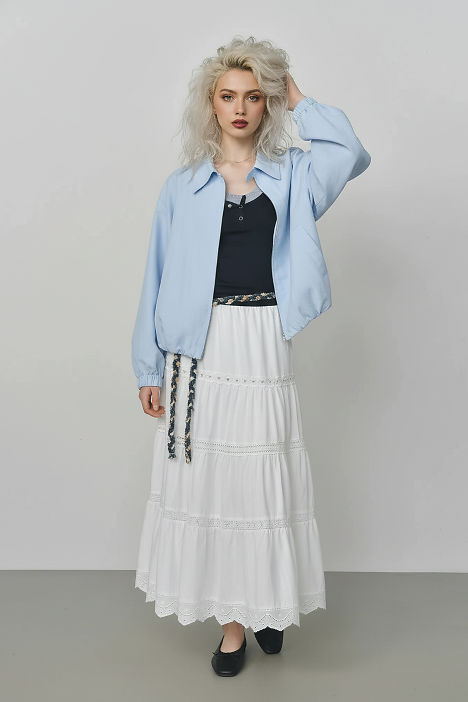 Beige short jacket, front view on model.