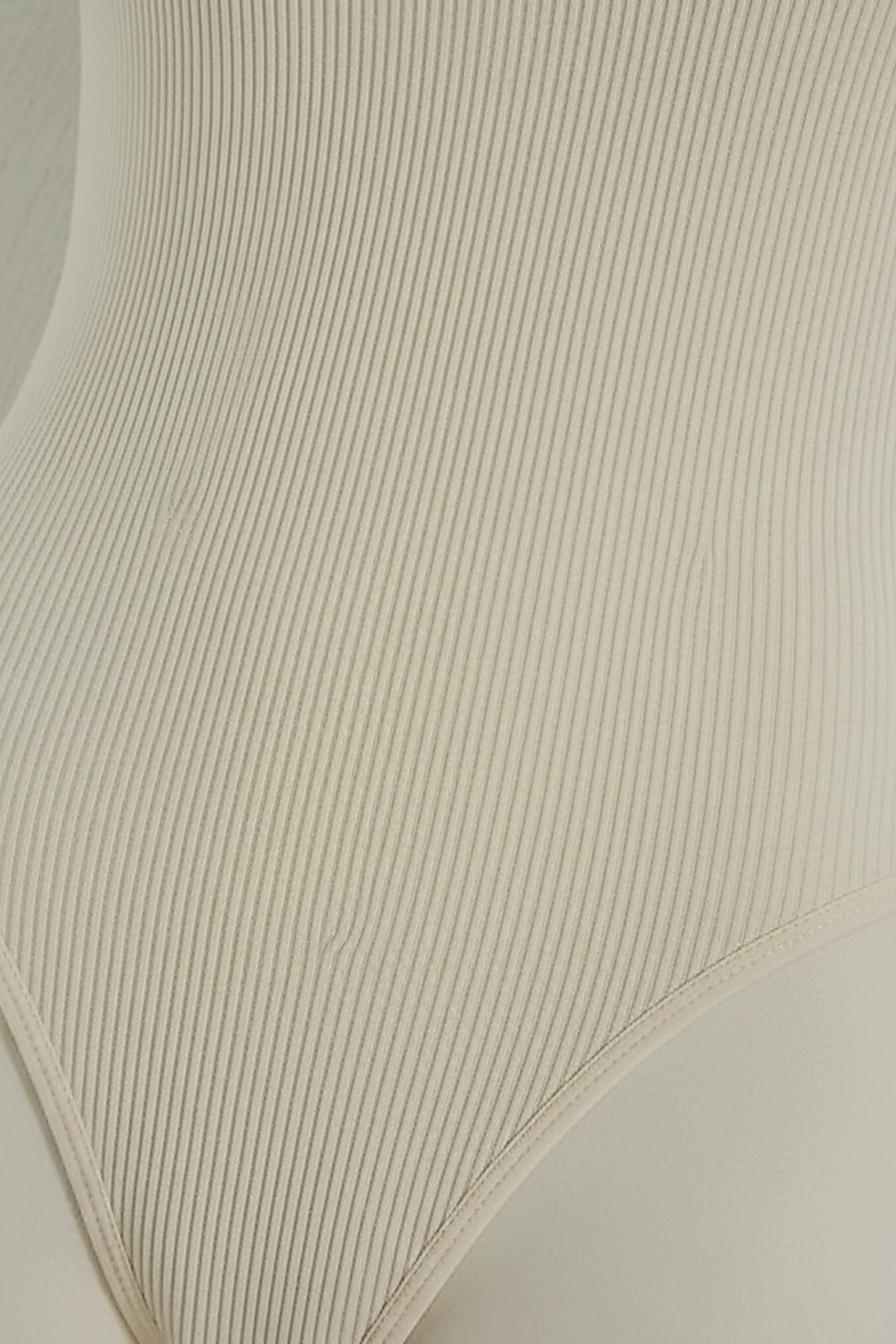 Ribbed jumpsuit fabric, close-up detail.