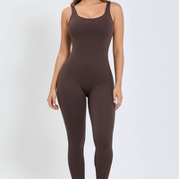 Black sports one-piece, side view on model.