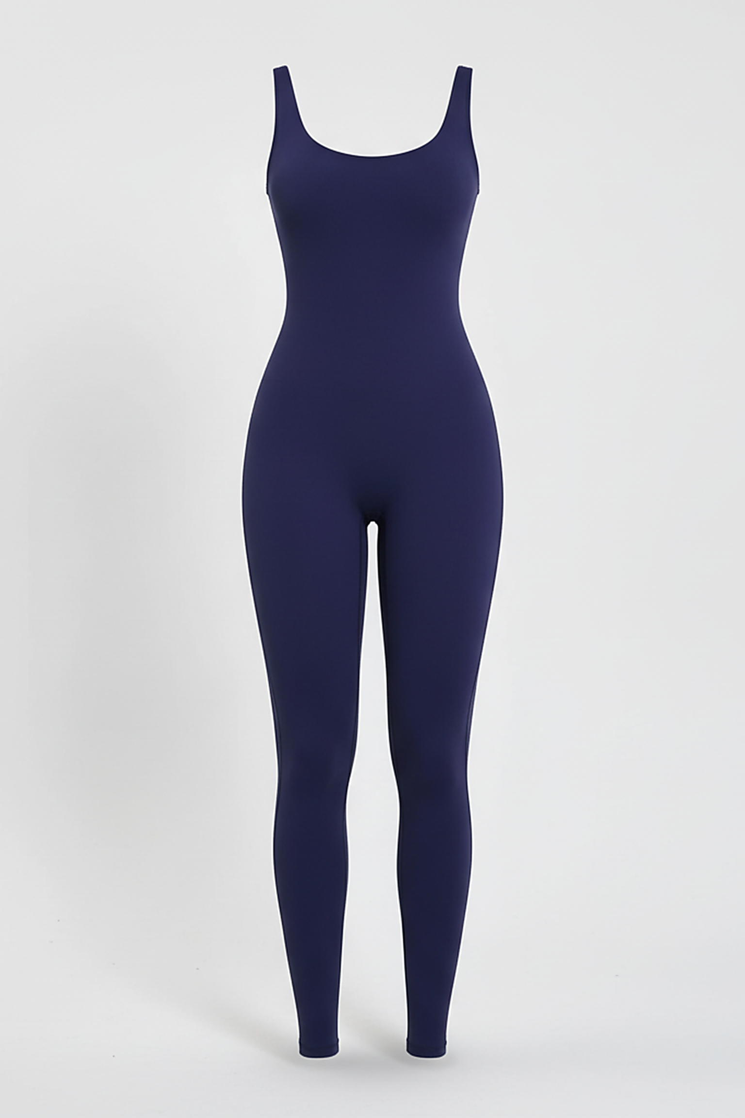 Black sports one-piece, dynamic pose on model.