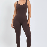 Black sports one-piece, back view on model.