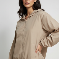 Orange transparent hooded jacket, hood detail with drawstrings.