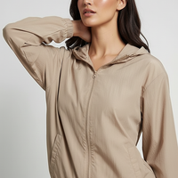 Orange transparent hooded jacket, side view on model.