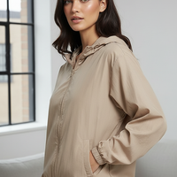 Orange transparent hooded jacket, fabric detail close-up.