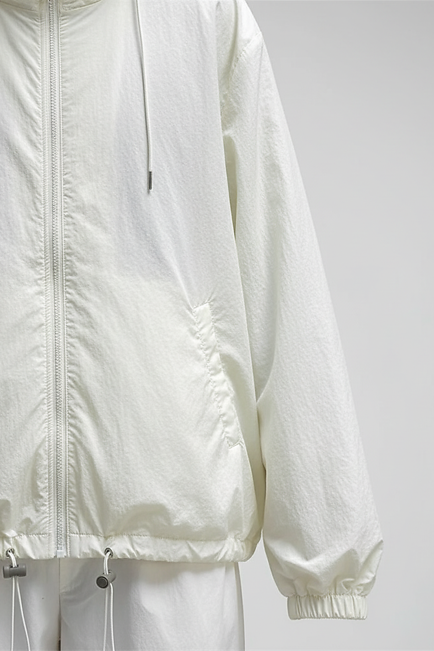 Orange transparent hooded jacket, sleeve and cuff detail.