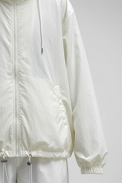 Orange transparent hooded jacket, sleeve and cuff detail.