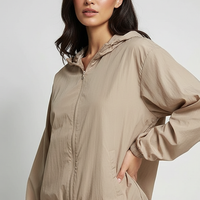 Orange transparent hooded jacket, front view on model.