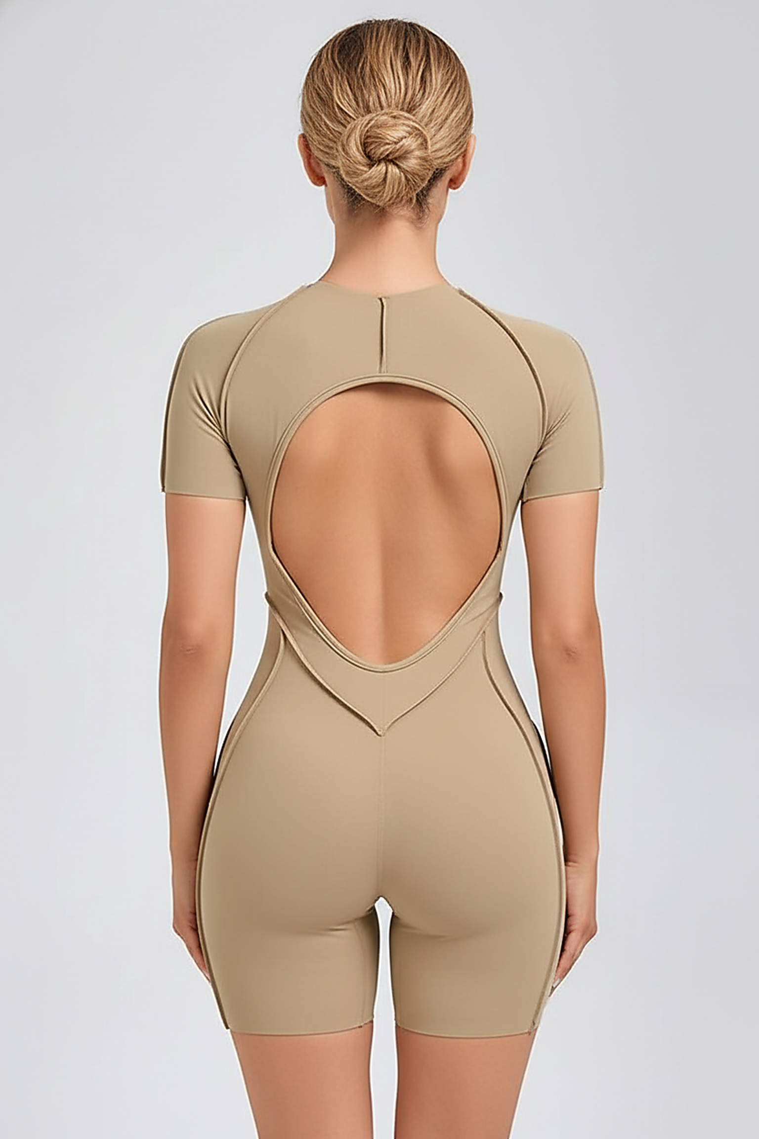 Black workout jumpsuit, back view on model.