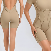 Black workout jumpsuit, close-up fabric detail.