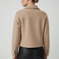 Women's solid long-sleeve jacket, back view on model.