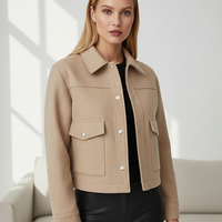 Solid long-sleeve jacket fabric detail.