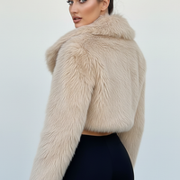 Cropped faux fur jacket, side view on model.