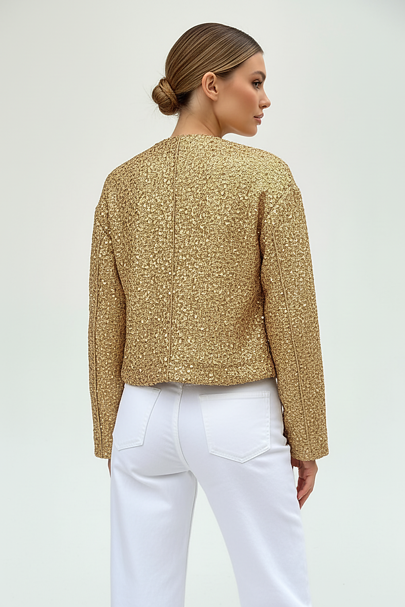 Gold sequin jacket, full length front view on model.
