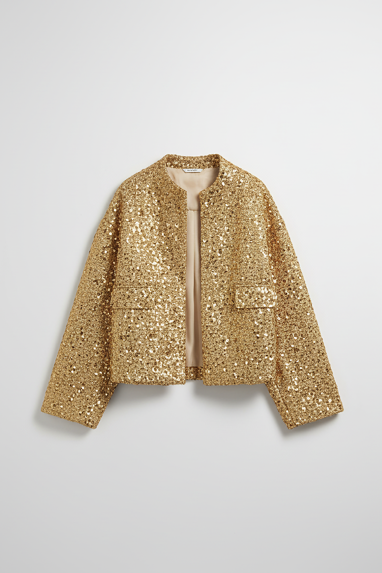 Gold sequin jacket, back view on model.