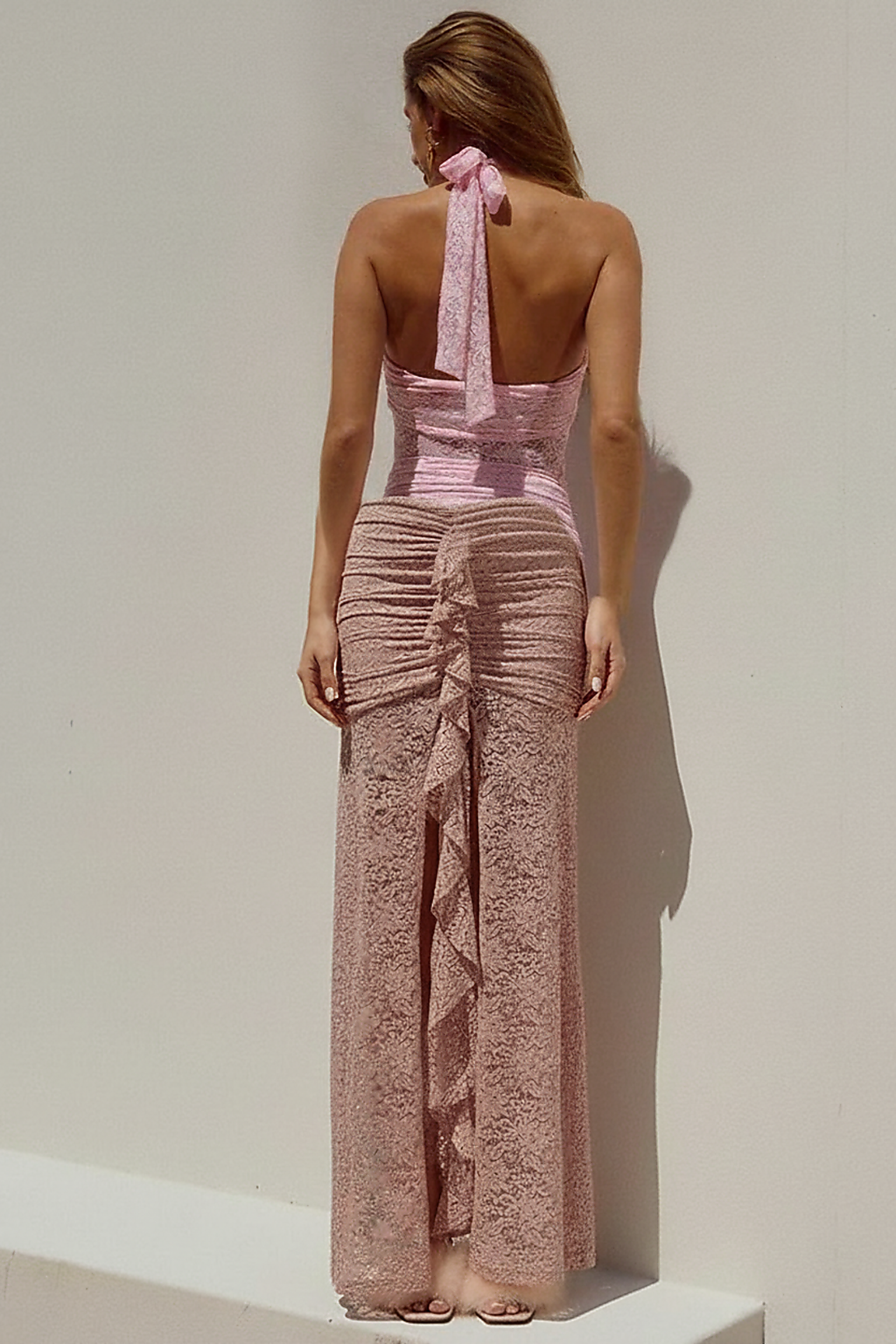 Black ruched maxi dress, side view on model.