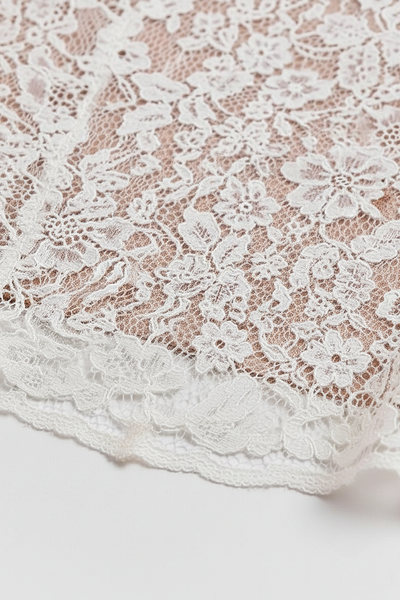 White lace long sleeve bodycon midi dress, front view on model.