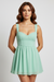 Solid color backless ruffle mini dress with cutouts, back view on model.