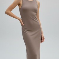 Brown sleeveless knitted dress, side view on model.