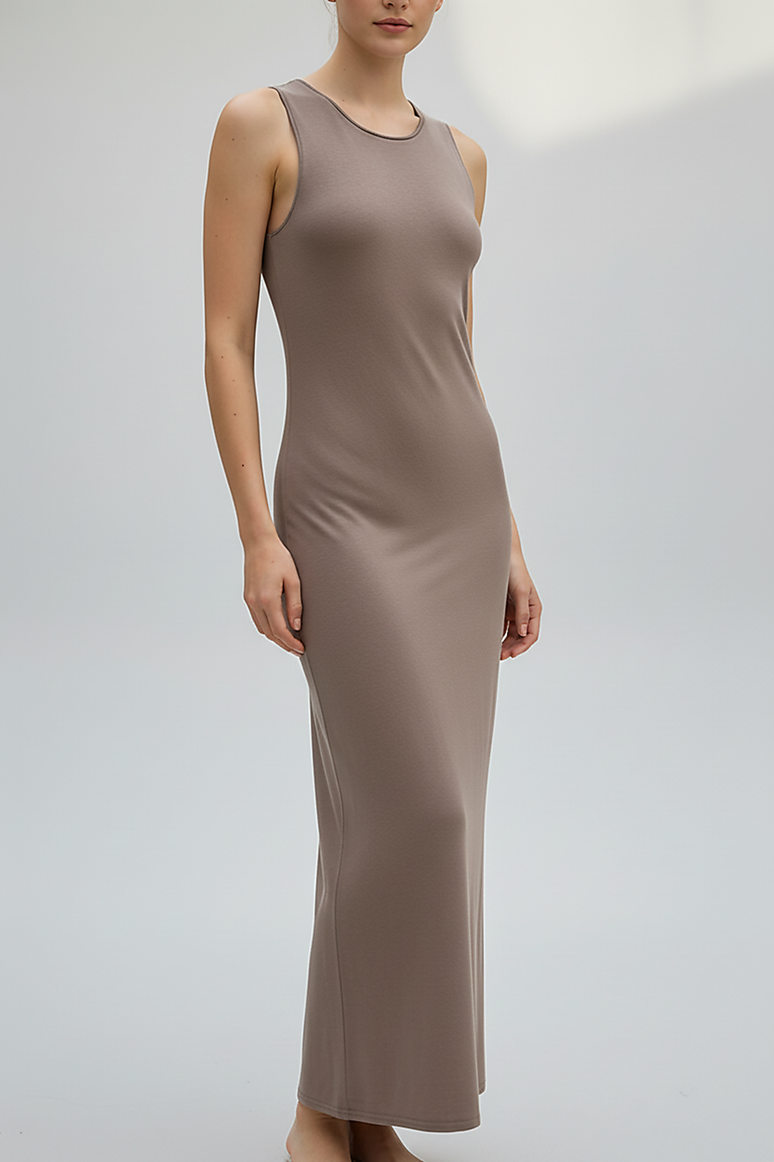 Brown sleeveless knitted dress, back view on model.