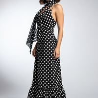 woman wearing white polka dot maxi dress, front view, standing, hands relaxed