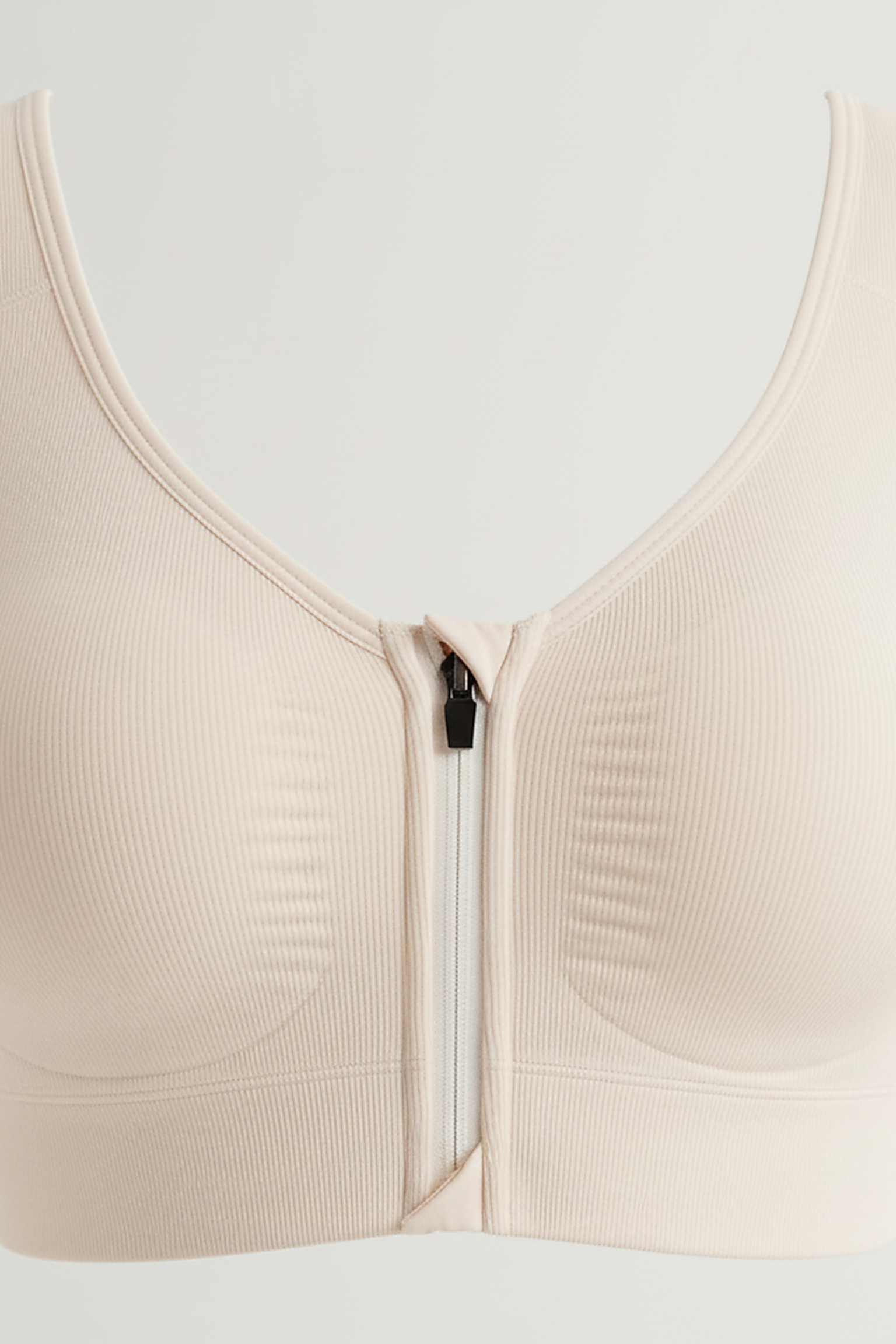 Sports bra front zipper fabric detail.
