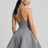 Backless halter pleated A-line mini dress, front view on model.