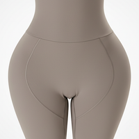 Black padded shapewear shorts, side view on model.