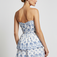 Black cut-out mini dress with layered hem, front view on model.