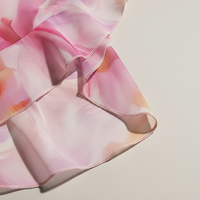 Floral print strapless bandage dress with irregular tassel patchwork, front view on model.