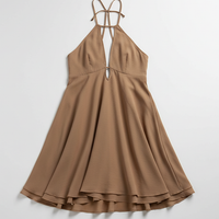 Halter ruffle mini dress with off-shoulder detail and backless design, on model.