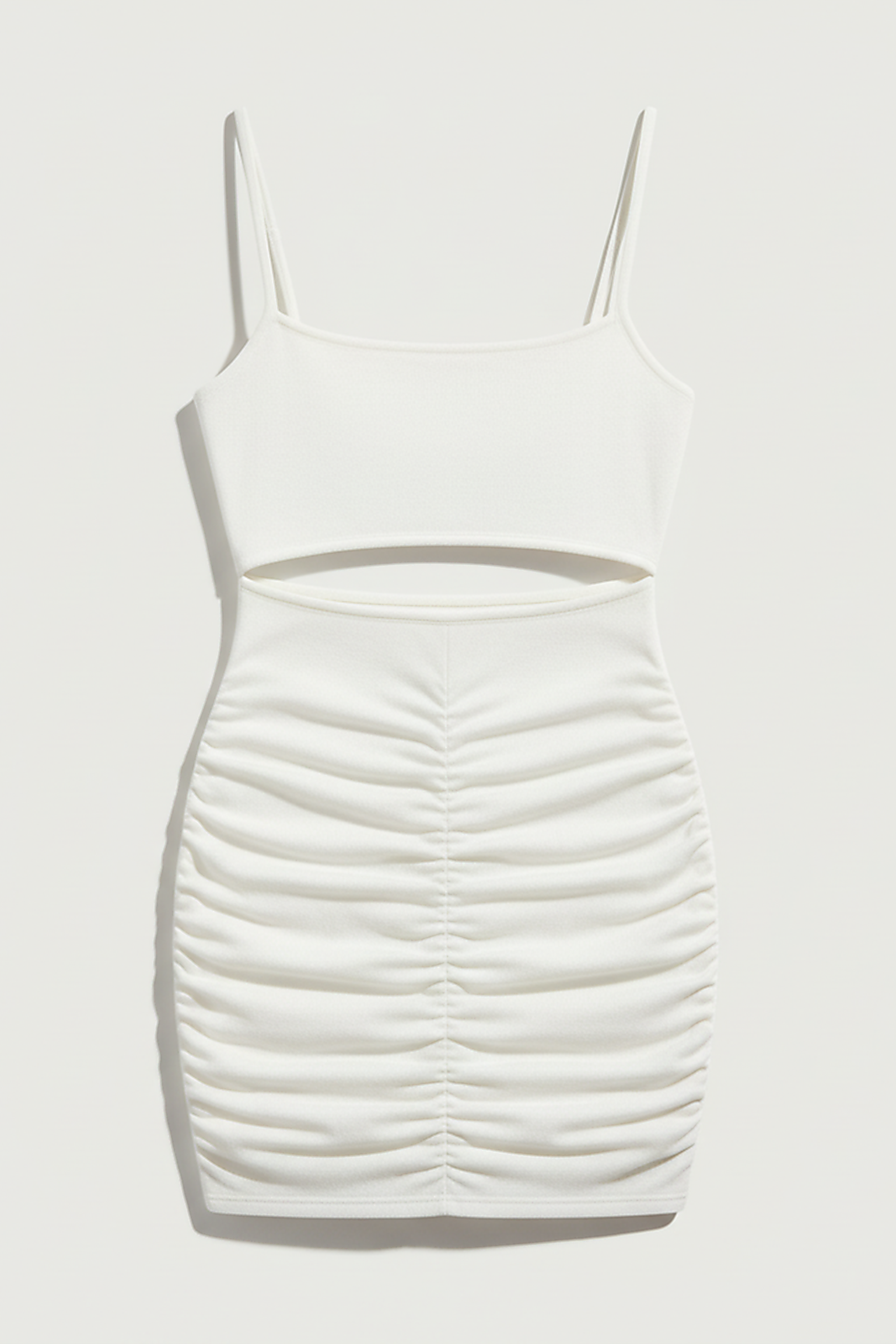 White spaghetti strap backless mini dress, evening style, on model.