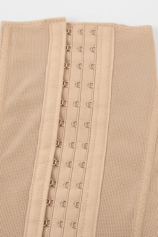 Black tummy control post-lipo faja shapewear, close-up fabric detail.