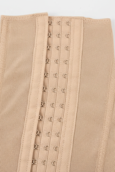 Black tummy control post-lipo faja shapewear, close-up fabric detail.