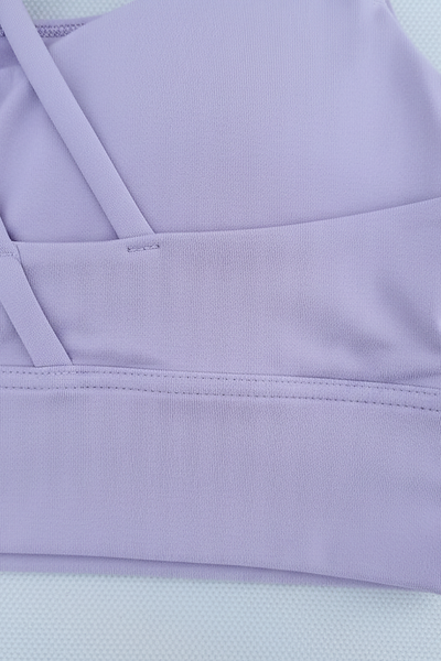 Women's breathable cross-back sports bra, push-up detail view.