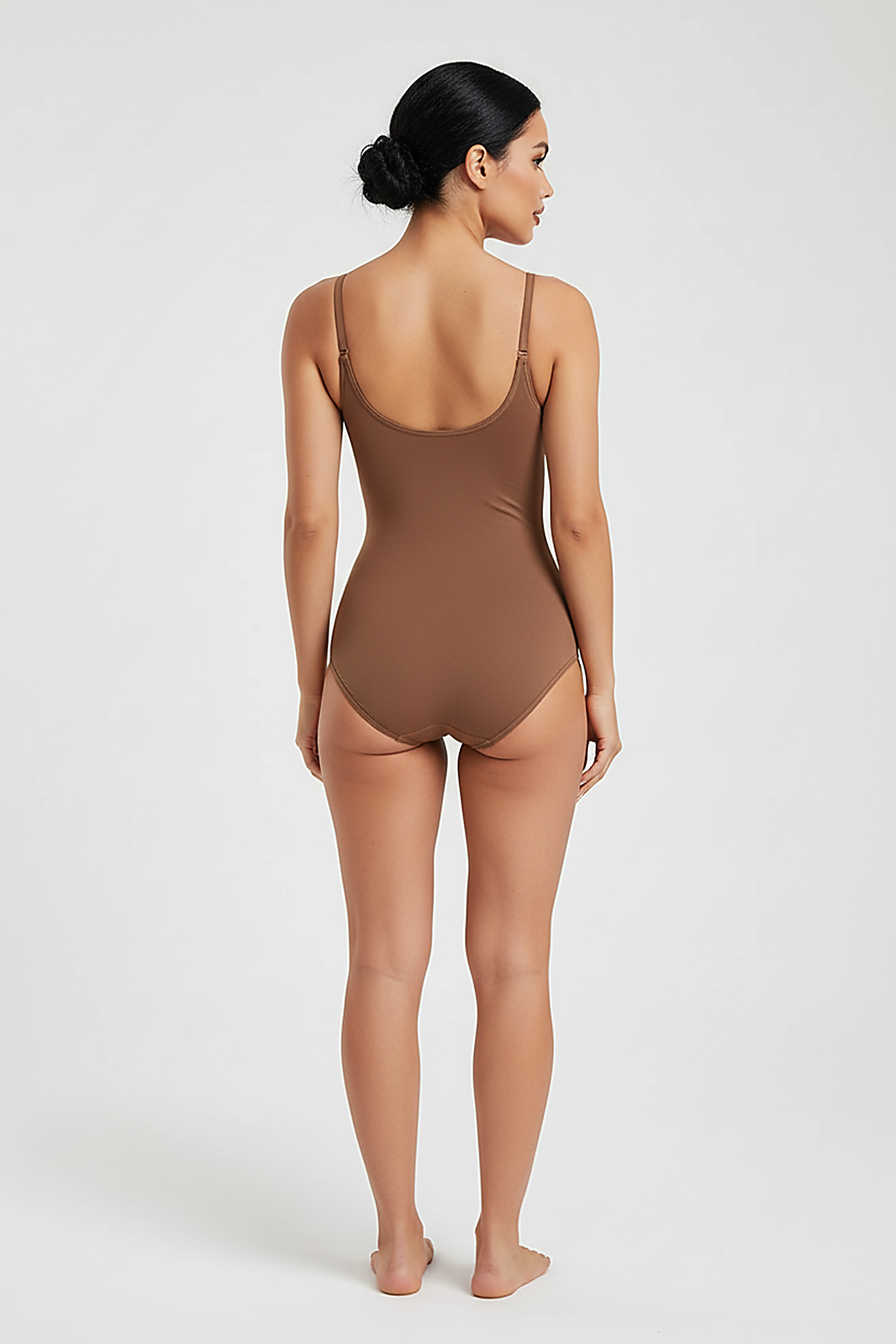 Women's seamless slimming butt lifter bodysuit, back view on model.