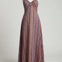 Flowy bohemian ethnic print maxi dress with frill trim, outdoor lifestyle.