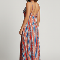 Boho ethnic print maxi dress with frill trim, outdoor lifestyle.