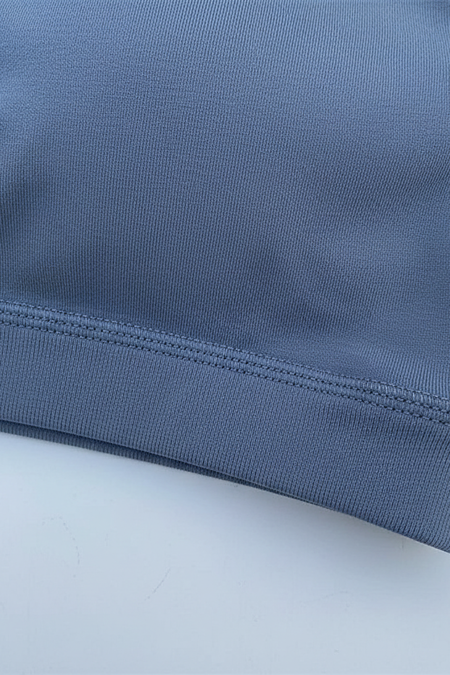 Women's solid fitness bra, fabric detail.