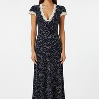 Flowy navy polka dot maxi dress with V-neck and lace trim, front view.