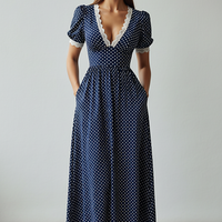 Navy blue polka dot maxi dress with lace trim, short sleeves.