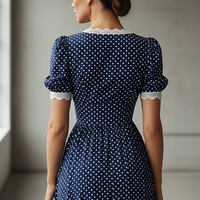 Navy polka dot A-line maxi dress with lace trim, front view.